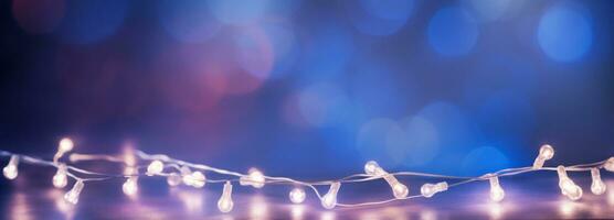 Light string isolated on blue and violet blur backgrounds photo