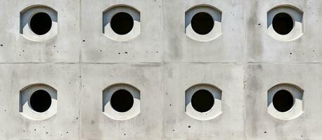 Wall made of cement with identical rectangular openings photo