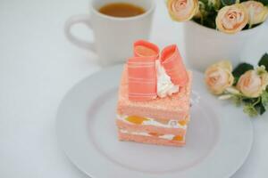 Slice of cake on white marble background. Selective focus. photo