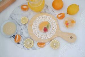 Fruit jelly with orange juice, lemon and kiwi on the table photo
