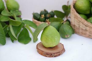 Fresh guava fruit in a basket on white background. Selective focus. photo