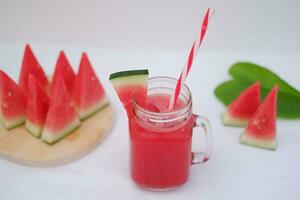 Watermelon smoothie in a glass jar with straws as a background photo