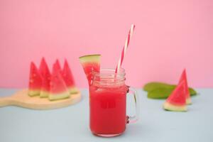 Watermelon smoothie in a glass jar with straws as a background photo