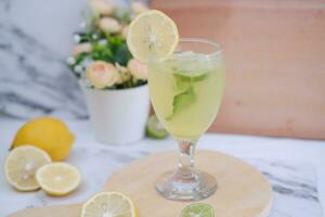 Lemonade with lime, mint and ice on a white background photo
