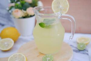 Lemonade with fresh lemon and mint leaves on a white background photo