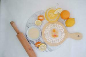 Yogurt with lemon, orange and grapefruit on white background photo