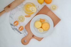 Orange jelly with fresh lemon and orange juice on a white background. photo