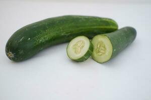 Cucumber and slices on a white background. Selective focus. photo