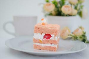 Slice of cake on white marble background. Selective focus. photo