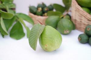 Fresh guava fruit in a basket on white background. Selective focus. photo