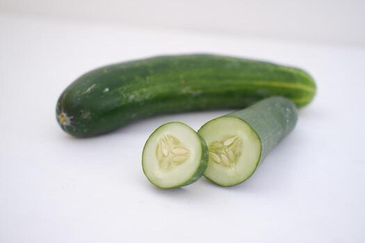 Cucumber and slices on a white background. Selective focus. photo