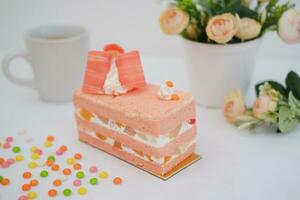 Slice of cake on white marble background. Selective focus. photo