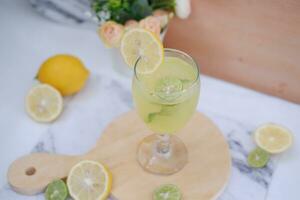 Lemonade with lime, mint and ice on a white background photo