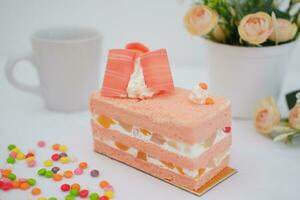 Slice of cake on white marble background. Selective focus. photo