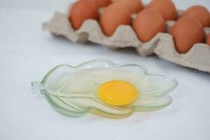 Eggs in a carton box on a white background. photo