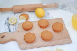 Lemon cake with lemon on wood background. Selective focus. photo