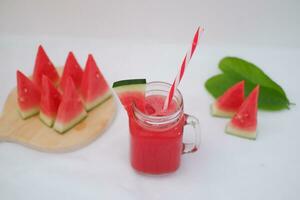 Watermelon smoothie in a glass jar with straws as a background photo