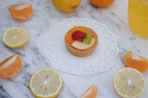 Fruit tartlet with orange, kiwi, strawberry and mandarin photo