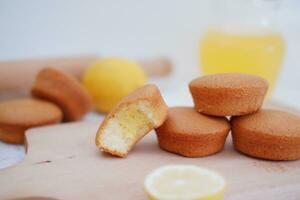Lemon cake with lemon on wood background. Selective focus. photo
