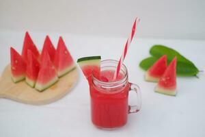 Watermelon smoothie in a glass jar with straws as a background photo