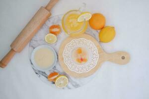 Yogurt with lemon, orange and grapefruit on white background photo