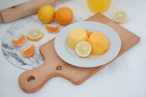 Orange jelly with fresh lemon and orange juice on a white background. photo