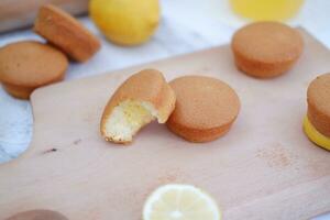 Lemon cake with lemon on wood background. Selective focus. photo