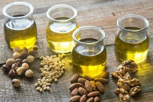 Glass jars with different kinds of nut oil photo