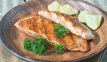 Roasted salmon steak with fresh parsley photo