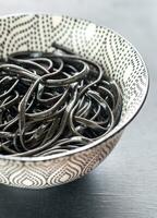 Bowl of black pasta photo