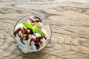 Chocolate ice cream with dessert topping photo