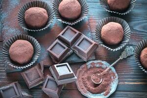 Rum balls with cocoa powder and chocolate slices photo