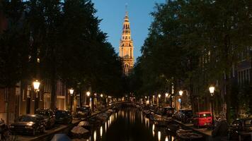 Night view of Amsterdam with canal and Zuiderkerk, Netherlands photo