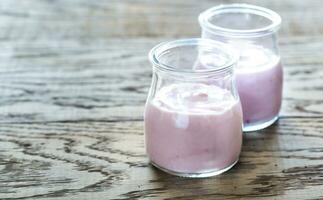 Glass jars of berry yoghurts photo