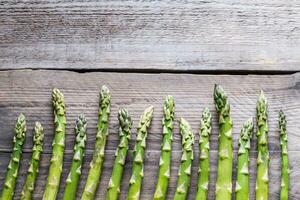 Fresh asparagus on the wooden background photo