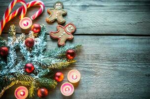 Decorated Christmas tree branch with cookies and candies photo