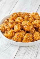 Bowl of orange chicken photo