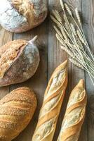 Different kinds of bread on the wooden background photo