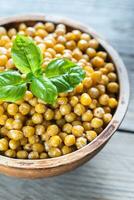 Bowl of roasted chickpeas on the wooden background photo