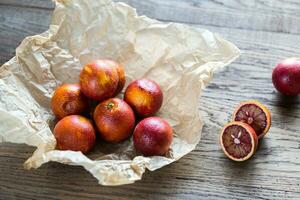 Red tangerines on the wooden background photo