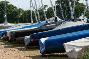 Row of Dinghy sailing boats photo