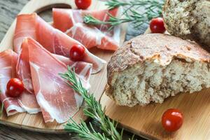 Slices of jamon on the wooden board photo