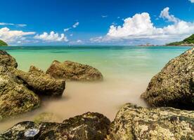 landscape view long exposure White sand beach clear blue water Nang Ram Beach, Chonburi Thailand early morning with blue sky white clouds perfect journey. On tourist travel holiday in summer of year photo