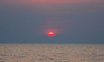 landscape viewpoint for design postcard and calendar summer sea wind wave cool on holiday calm sea coastal area big sunset sky light orange golden evening hours day At Chonburi Thailand photo