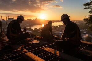 Silhouette of Engineer and worker checking project at top building site background, photo