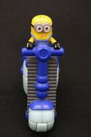 minion figure toy ride bicycle photo