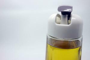 A large drinking bottle containing a yellow drink with a white lid photo