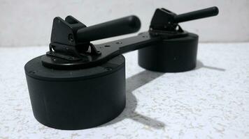 Black vacuum suction cup for removing tiles from floor photo