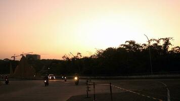 Sunset view from the street with silhouettes of trees photo