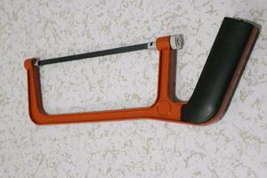 Close-up of orange hacksaw photo